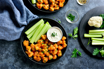 Cauliflower buffalo wings with celery and sauce
