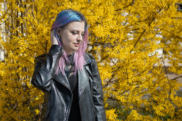 Young blue violet haired girl in yellow leaf