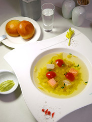transparent salmon soup with cherry tomatoes and vodka