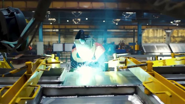 Accurate Manual Work of a Skilled Welder at Modern Factory of Rail Car Train Carriage Manufacture Modern Metallurgy Tracking Blacksmith Sparks Slow Motion