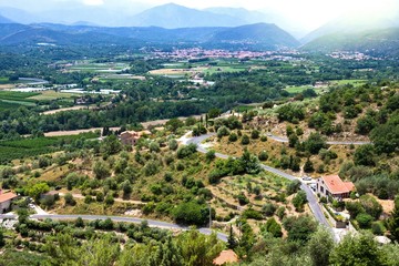 Views of Languedoc-Roussillon from village Eus, France. Tiled roof houses, vineyards and mountains...