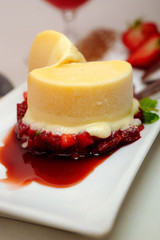 yellow ice cream with strawberries and mint leaves