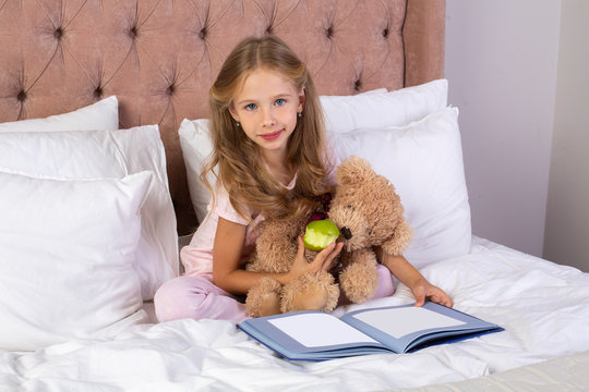 Little pretty girl read book in bedroom