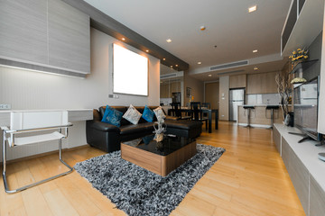 Beautiful and large living room interior with hardwood floors and vaulted ceiling in new luxury home.