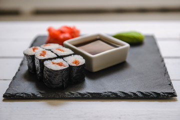 Japanese traditional rolls served in a sushi bar on white table. Sushi menu. Japanese food concept. Place for text