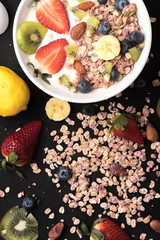 Granola. Granola with yogurt, on black wooden table
