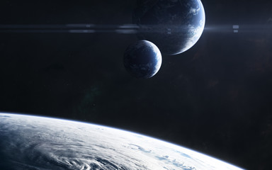 Planets somewhere in deep space in light of blue star. Science fiction. Elements of this image...