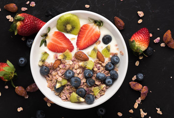 Granola. Granola with yogurt, on black wooden table
