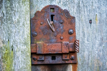 old rusty lock with a key on wooden door