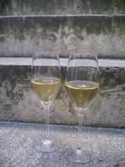 two glasses of champagne on stone stairs