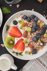 Granola. Granola with yogurt, on black wooden table