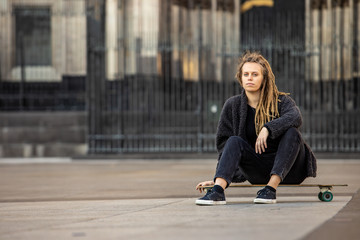 Portrait of skateboarding woman in Cologne city