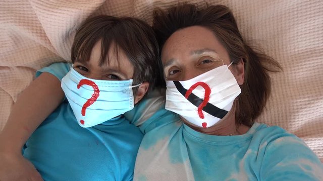 4K Lockdown isolation selfies - Asking questions Mother and child in masks against fake pandemic

