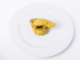 Artificial Poo On White Plate Against White Background