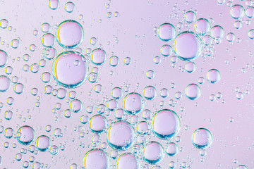 oil with bubbles on coral background. Pink Abstract space background. Soft selective focus. macro...