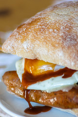 Sausage and Egg Butty with Brown Sauce, a British staple.