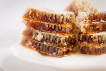 honey, pollen, wax candles and other bee products in beautiful packages with labels flat lay