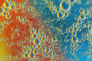 Colorful abstract background. Blue orange purple pink and red circles and oil bubbles in the water....