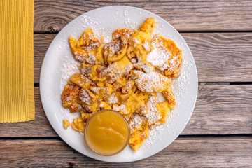 Kaiserschmarren desert on white plate wooden table