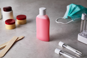 hand sanitizer gel in a pink pot on the table of a hospital filled with elements against coronavirus