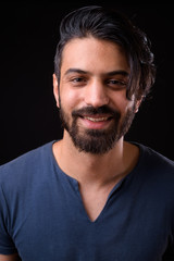 Fototapeta premium Face of happy handsome bearded Persian man smiling