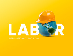 Minimal May first International Workers Day. International labor day design helmet and world together on the yellow background. 