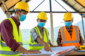 Team engineers and  builders having wearing protective masks to prevent dust and covid 19 disease...