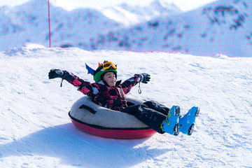 Boy Having Fun on a Snow Tube