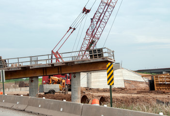 Highway construction with crane closeup