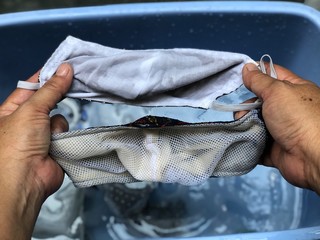 Cotton cloth mask soak in blue tank after the used and washing,natural glare light,the mask repeated use 2-3 times,after use every day should wash and dry in the sun to be sterilized as well.