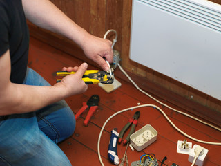 Electrician maintaining new electric heater