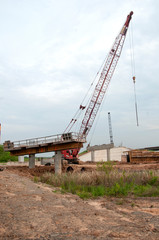 Fototapeta na wymiar Highway overpass construction with tall crane