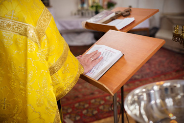 The priest put his hand on the holy bible in the Orthodox Church