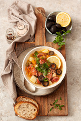 Traditional meat Russian soup solyanka on wooden board