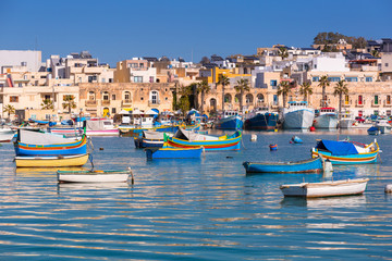 Fototapeta na wymiar Traditional fishing boats in the Mediterranean Village of Marsaxlokk, Malta