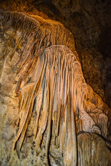 Calcite inlets, stalactites and stalagmites in large underground halls in Carlsbad Caverns National...