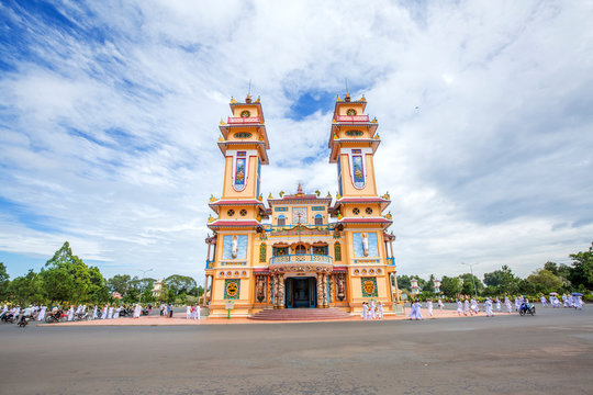 Cao Dai temple area and meditating followers of the Cao Dai religion in the temple Cao Dai, Tay Ninh, Vietnam