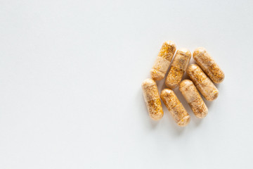 Vitamin pills on a white background top view