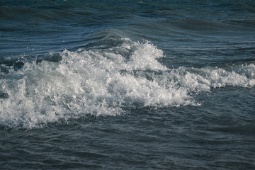 Sea waves with white foam close up