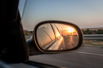 Sunset reflection in the car mirror 
