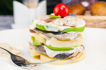 Herring salad with avocado potatoes filmed close-up.
