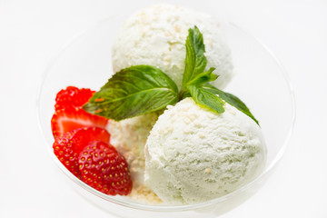 Ice cream balls decorate with mint on a white background in a restaurant.
