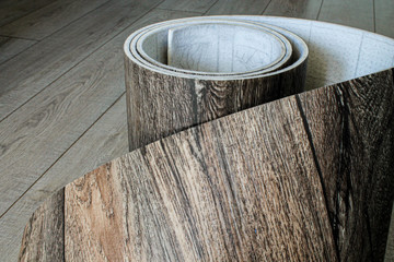 Obraz premium Roll of linoleum with a wood texture. Types of floor coverings. 