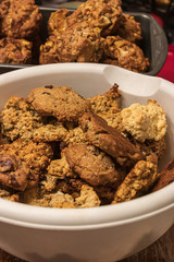 a bowl of various cookies set out on the table