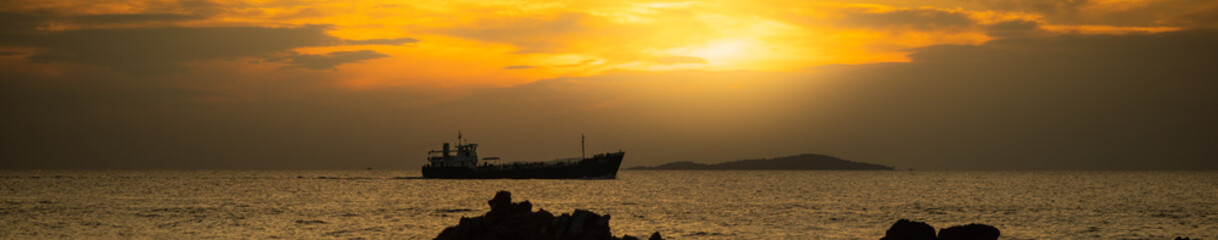 Fototapeta premium Beautiful nature view of boat on blurred sunset with copy space using as background natural landscape, fresh cover page, world oceans day concept.