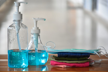 Hand sanitizer gel and facemasks in front of the office's doors for the officers to clean hands and wear before getting inside to protect and prevent Covid-19 virus or Coronavirus and germs.