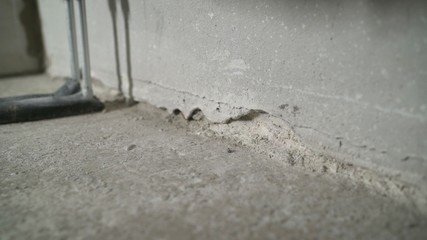 construction cleaning service sleeve anchor bolt . dust removal with vacuum cleaner. Cleaning construction dust with a construction vacuum cleaner. Floor repair in a new apartment.