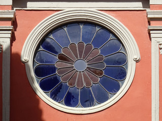 Rose window with red and blue glazed petal shapes. Malaga. Spain. 