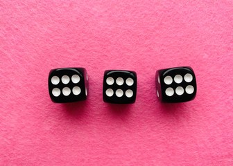 Black dice on pink background 666