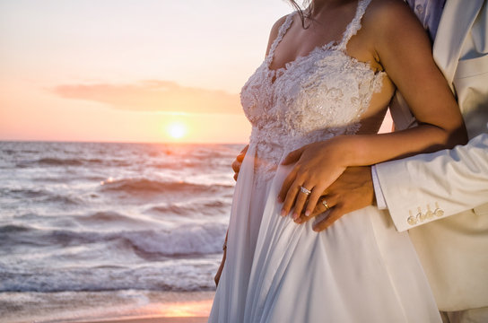 Bride And Groom On The Beach At Sunset 